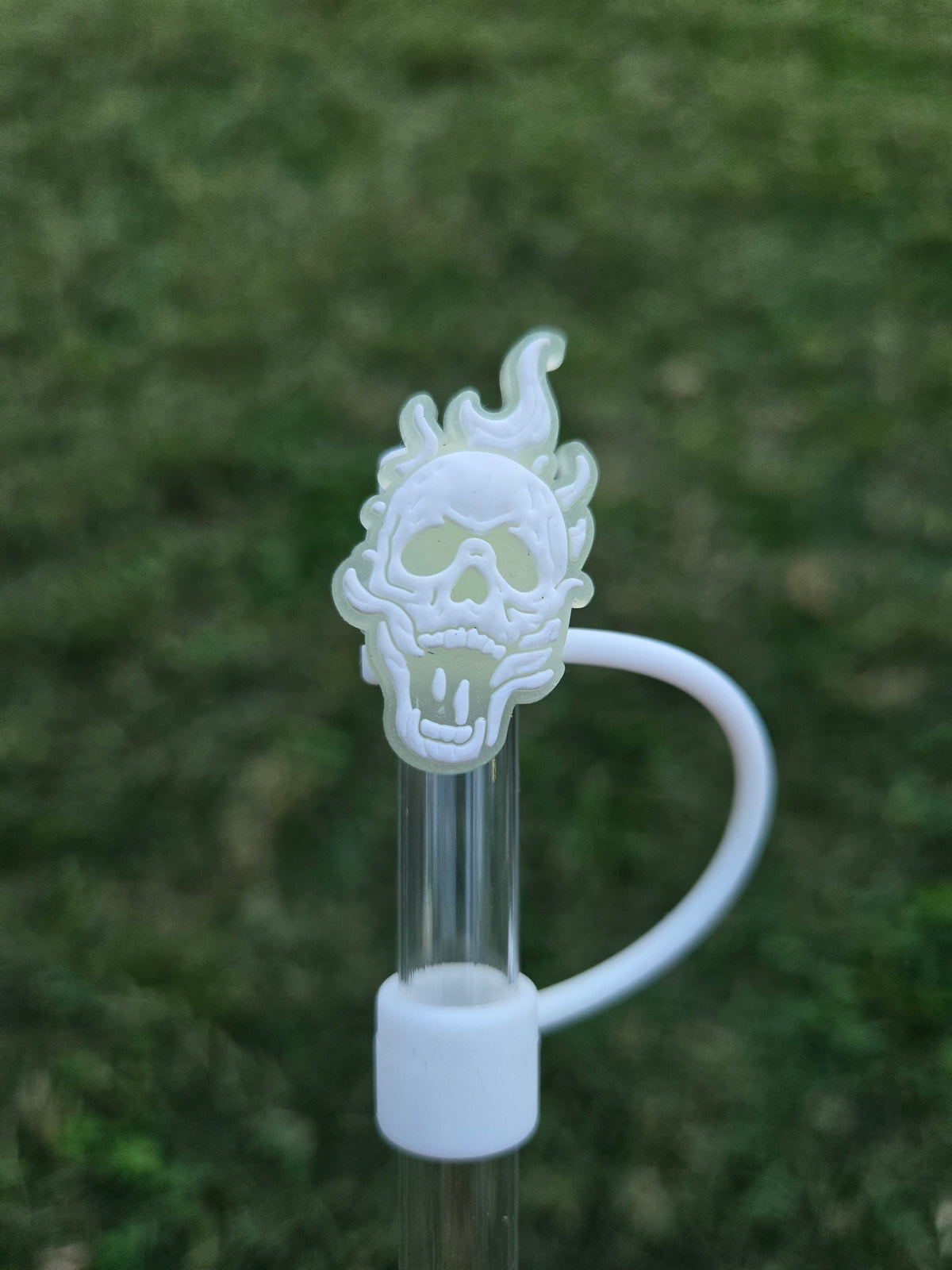 Glow in the dark white flaming skull Halloween straw topper attached to clear tumbler straw