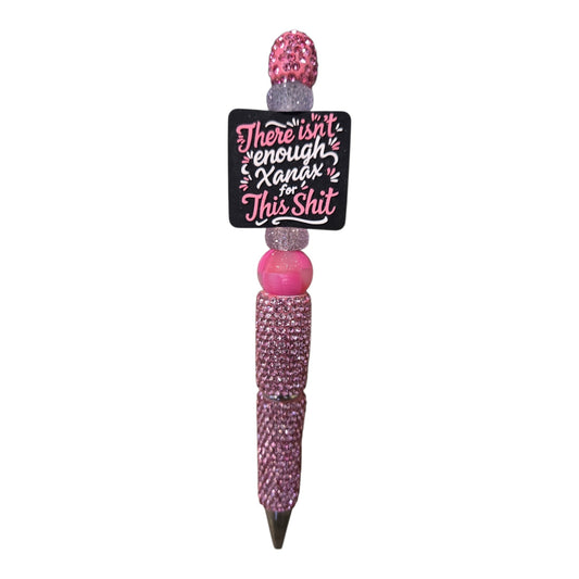 A pink rhinestone-covered pen with a black square charm that reads 'There isn't enough Xanax for This Shit' in pink and white lettering, shown on a plain white background.