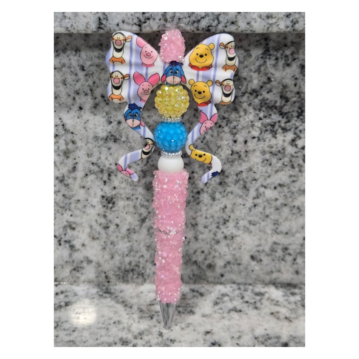 Pink sparkling bling pen with Winnie the Pooh, Piglet, Tigger, and Eeyore bow, yellow and blue beads, and white accents
