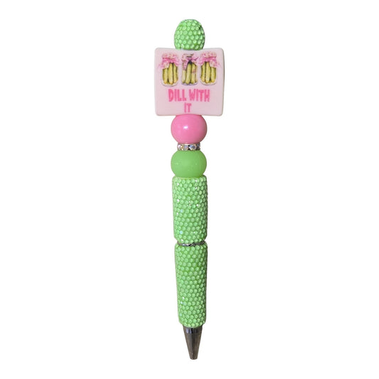 THE SALTY CHIC Dill With It beaded pen featuring lime green textured beads, a pink charm, and pickle illustrations.