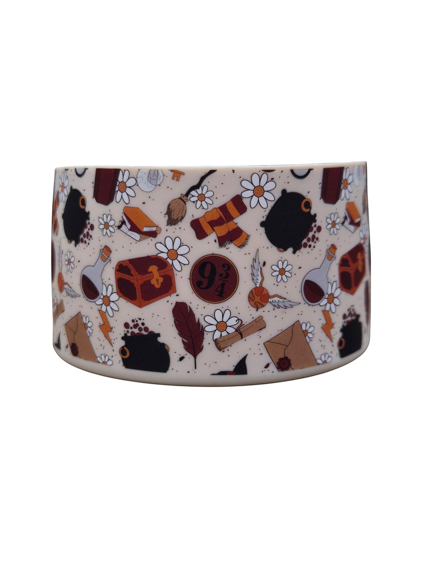 THE SALTY CHIC Harry Potter themed silicone tumbler boot with magical icons and daisies on a tan background