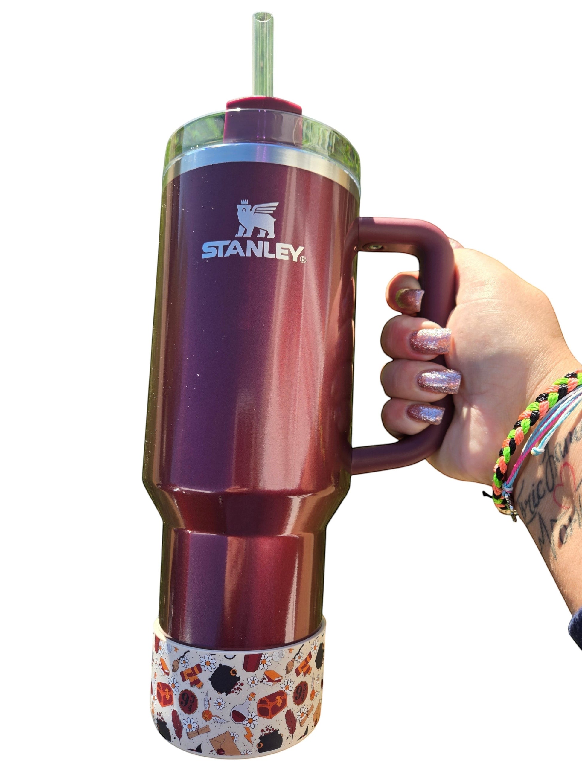 THE SALTY CHIC Harry Potter themed silicone tumbler boot on a maroon Stanley cup held by a hand