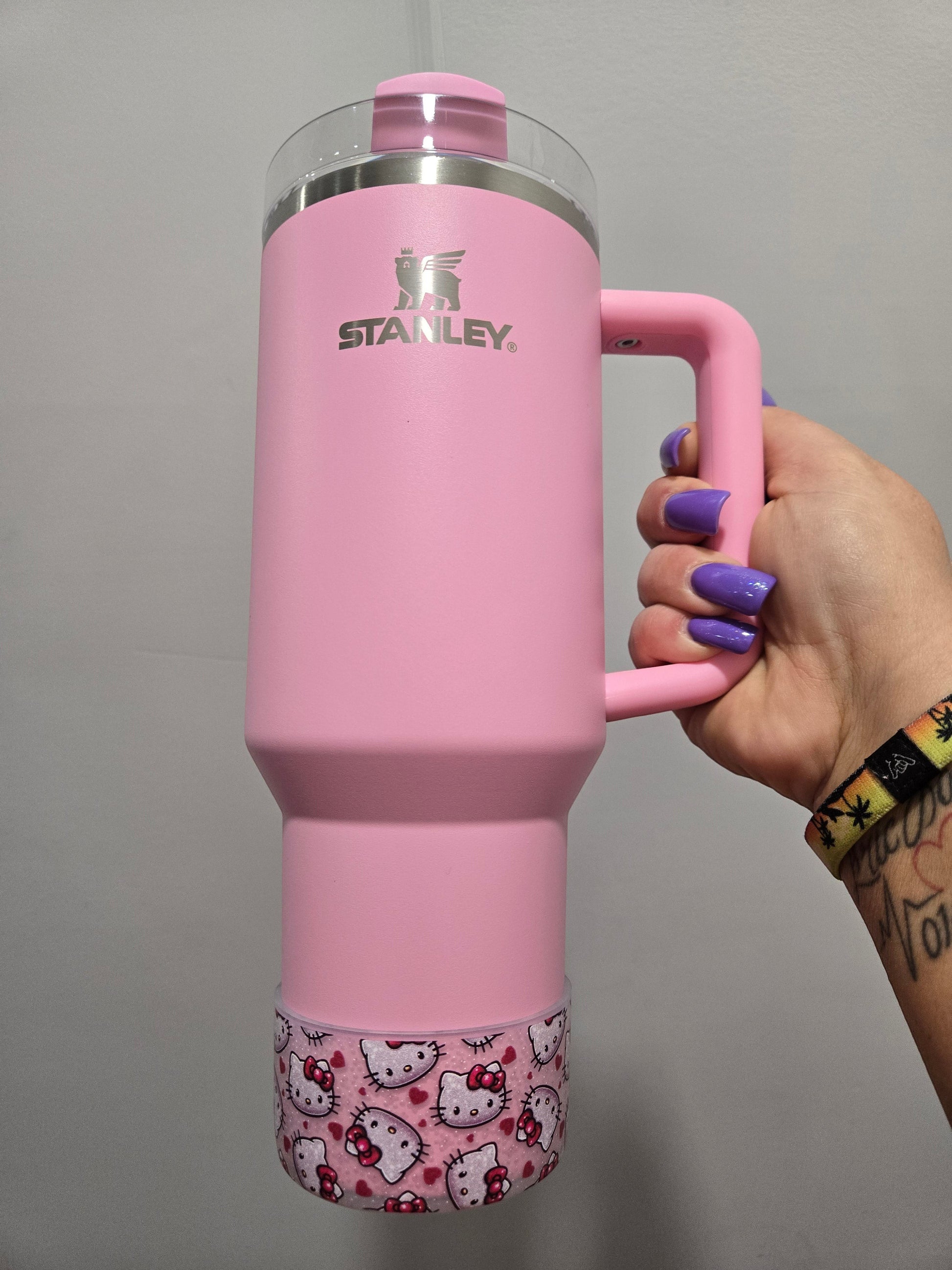 THE SALTY CHIC pink Stanley tumbler with a clear silicone Hello Kitty and heart print protective boot base