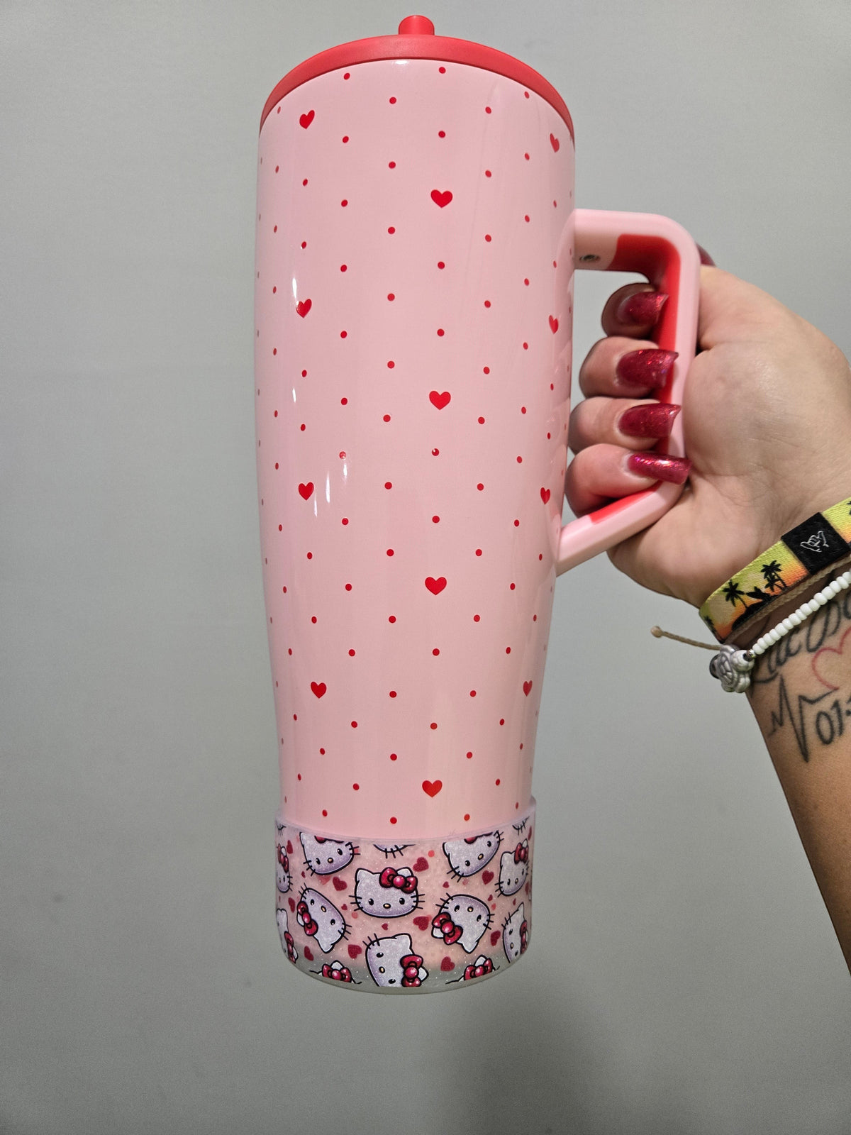 THE SALTY CHIC clear silicone tumbler boot featuring a Hello Kitty and heart pattern on a pink polka dot brumate era