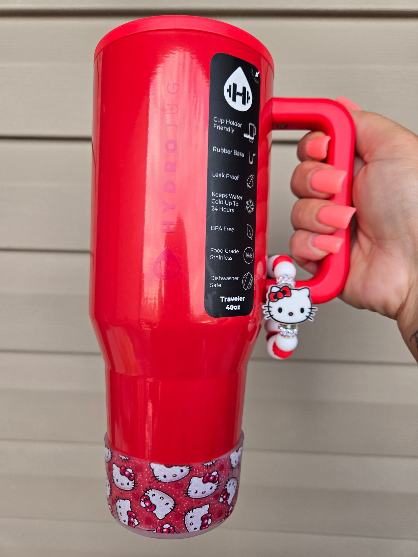 THE SALTY CHIC silicone tumbler boot featuring a Hello Kitty and heart pattern on a red HydroJug traveler cup