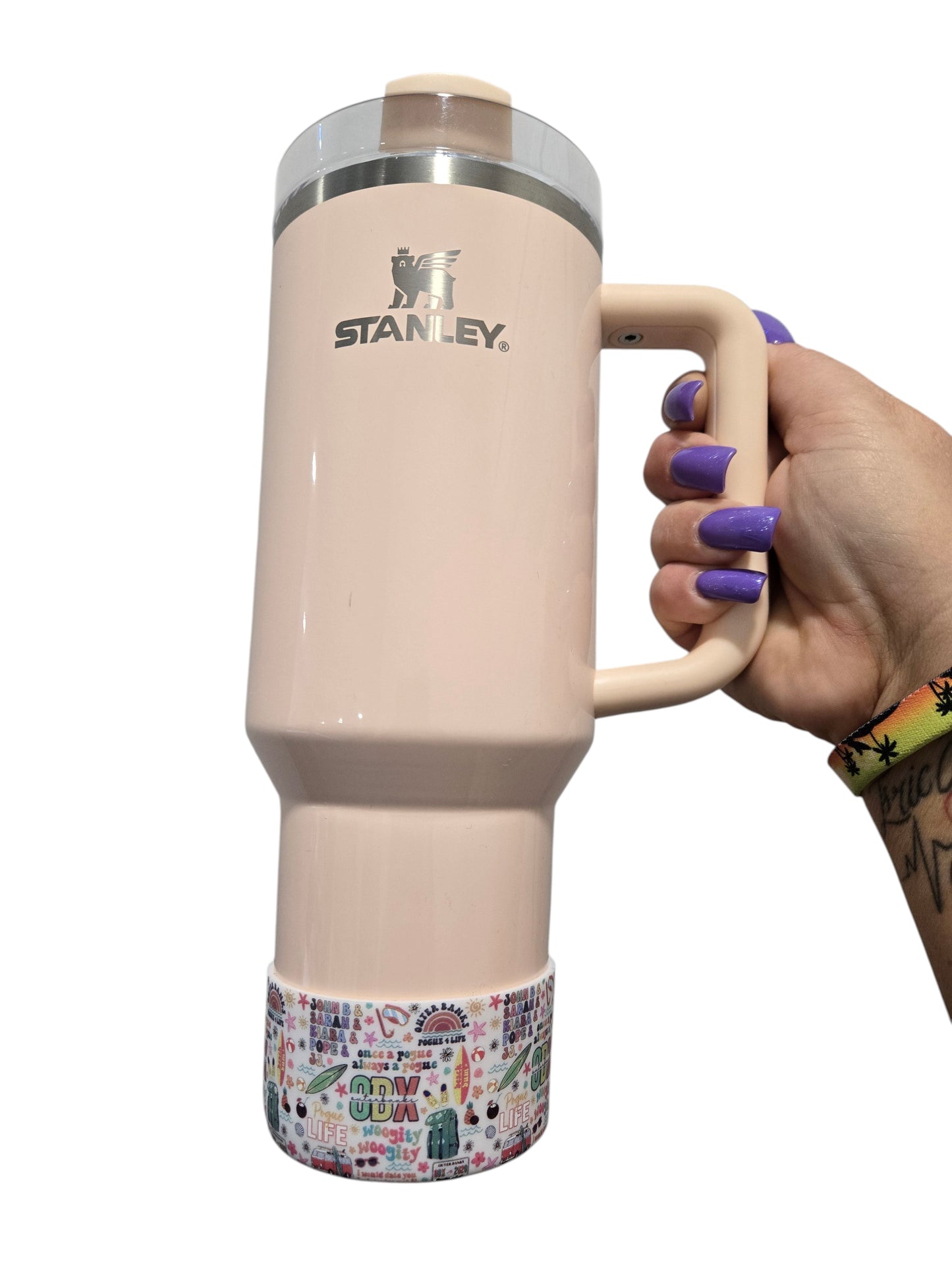 THE SALTY CHIC Outer Banks tumbler boot on a light pink Stanley cup, featuring a colorful beach-themed pattern.